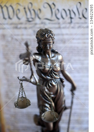 Lady Justice old statue and US Constitution blurred page close up. Lawsuit and justice in United States of America Lady Justice old statue and US Constitution blurred page close up. Lawsuit and justice in United States of America 134622695