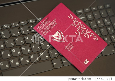 Kyprus passport lies on black laptop keyboard buttons background close up. Technologies and control in Europe concept 134622741