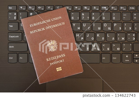 Austria passport lies on black laptop keyboard buttons background close up. Technologies and control in Europe concept 134622743