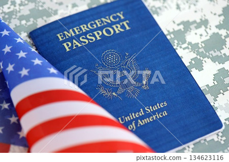 United States emergency passport book with US flag on camouflage uniform close up. Travel document on camo fabric photo United States emergency passport book with US flag on camouflage uniform close up. Travel document on camo fabric photo 134623116