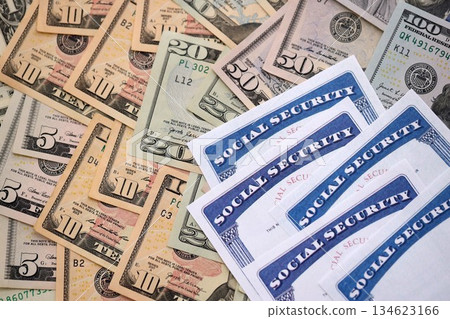 Social security number cards on many US dollar money bills close up 134623166