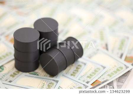 Barrels of oil on bills of American dollars. purchase, sale of oil concept close up Barrels of oil on bills of American dollars. purchase, sale of oil concept close up 134623299