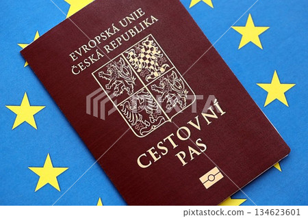 Czech biometrical passport on European Union flag background. Concept of citizenship of Czech Republic Czech biometrical passport on European Union flag background. Concept of citizenship of Czech Republic 134623601