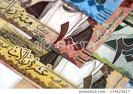Saudi Arabia riyal money bills banknotes lies in big pile on table close up. Concept of finances and business in Saudi Arabia Saudi Arabia riyal money bills banknotes lies in big pile on table close up. Concept of finances and business in Saudi Arabia 134623617