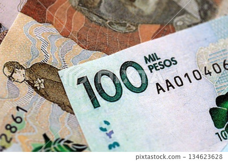 Colombian pesos money bills banknotes lies in big pile on table close up. Concept of finances and business in Colombia 134623628