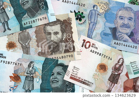 Colombian pesos money bills banknotes lies in big pile on table close up. Concept of finances and business in Colombia 134623629