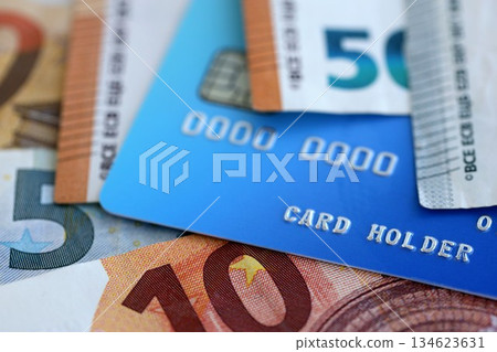 Euro money bills banknotes and credit card for cashless payments. Concept of banking service in European Union countries Euro money bills banknotes and credit card for cashless payments. Concept of banking service in European Union countries 134623631