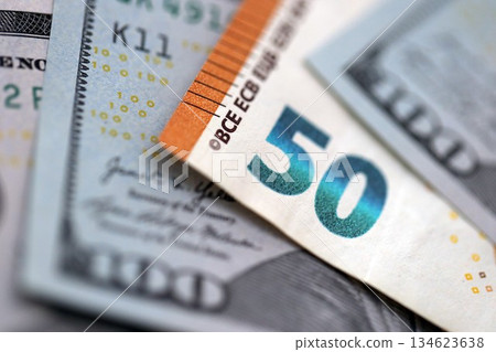 One hundred US dollar bill banknotes and fifty european Euro currency banknote. Concept of currency exchange between USD and EUR 134623638