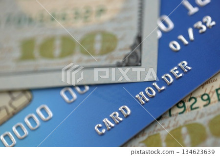 One hundred US dollar bill banknote on blue credit card for banking and payments. Concept of business and bank service 134623639