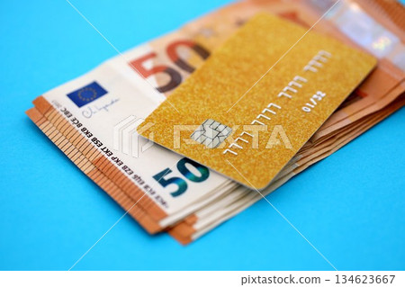 Credit card and pen with euro currency money bills banknotes on light blue background. Business, financial operations and accounting in European Union 134623667