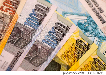 Congolese franc money bills in big amount on table close up. Rich life concept in Democratic Republic of Congo. Business and economy Congolese franc money bills in big amount on table close up. Rich life concept in Democratic Republic of Congo. Business and economy 134623695