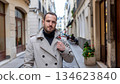 A male detective walking down an alley in France 134623840