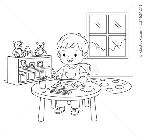 A boy is sitting at a table with a paintbrush and a piece of paper A boy is sitting at a table with a paintbrush and a piece of paper 134624271