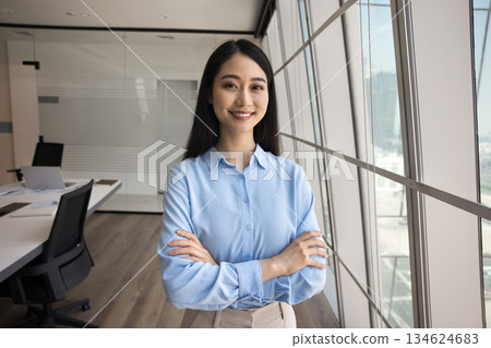 Confident Asian businesswoman, staff member posing in conference room 134624683
