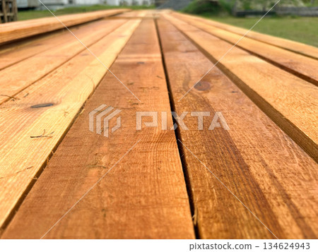 lumber close-up. Light wooden boards stacked in rows. lumber close-up. Light wooden boards stacked in rows. 134624943