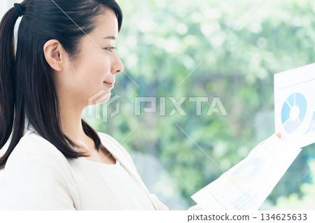A young woman creating documents on a computer A young woman creating documents on a computer 134625633
