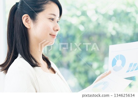 A young woman creating documents on a computer A young woman creating documents on a computer 134625634