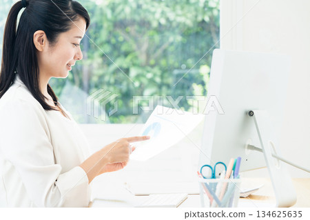 A young woman creating documents on a computer A young woman creating documents on a computer 134625635