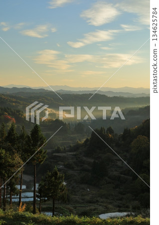 A view of the rice terraces at Hoshitoge in Tokamachi shrouded in mist in the early autumn morning 134625784