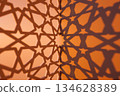 Intricate Shadow Patterns on Orange Wall 134628389