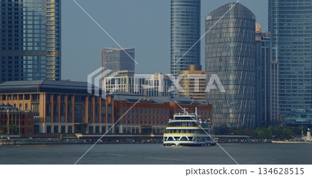 Modern ferry approaching waterfront with historical architectural contrast. Shanghai, China 134628515