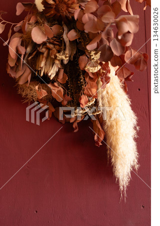 Dried flowers on a red wall Dried flowers on a red wall 134630026