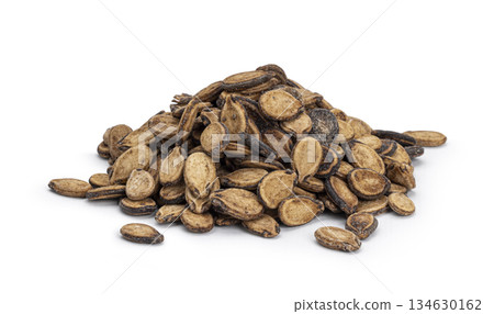 Pile of dried watermelon seeds on white background Pile of dried watermelon seeds on white background 134630162