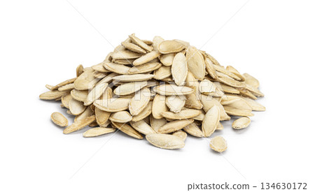 Pile of roasted salted pumpkin seeds on white background 134630172