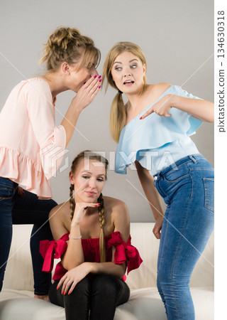 Woman being bullied by two females Woman being bullied by two females 134630318