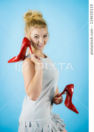 Fashion stylist presenting high heels Fashion stylist presenting high heels 134630319