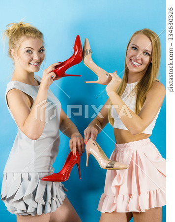 Women presenting high heels shoes Women presenting high heels shoes 134630326