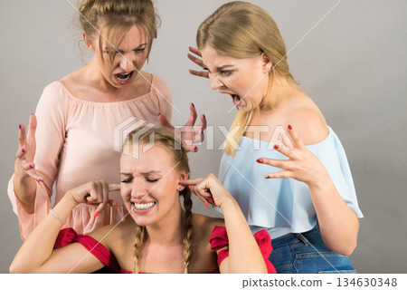 Woman being bullied by two females 134630348
