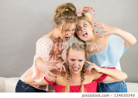 Woman being bullied by two females Woman being bullied by two females 134630349