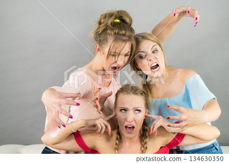 Woman being bullied by two females 134630350
