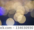 Abstract Bokeh from indoor lighting, Blue with orange with gold and yellow circles spread on  black colored surface, Night city light background for celebration of christmas and holiday season 134630930