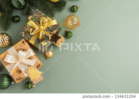 Border fron Christmas Gifts with Ornaments and Evergreen Branches on Festive Background 134631204