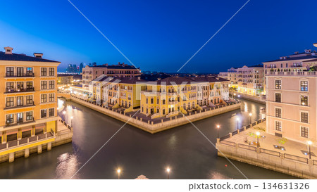 Canal aerial top view in Venice-like Qanat Quartier of the Pearl precinct of Doha day to night timelapse, Qatar. 134631326