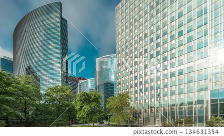 Timelapse panorama of modern office buildings. Glass skyscrapers with reflections and highlights 134631354