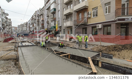 Concrete works for road maintenance construction site with many workers and mixer timelapse Concrete works for road maintenance construction site with many workers and mixer timelapse 134631376
