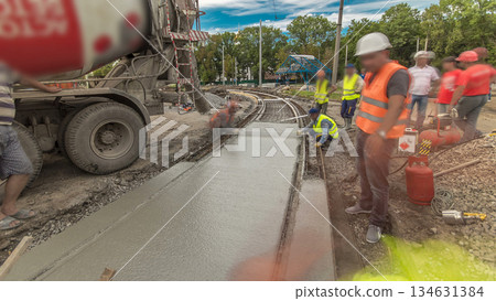Concrete works for road construction with many workers and mixer timelapse hyperlapse Concrete works for road construction with many workers and mixer timelapse hyperlapse 134631384
