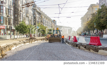 The bulldozer moves and spreads the soil and rubble on the road timelapse. 134631389
