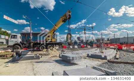 Installing concrete plates by crane at road construction site timelapse. 134631400