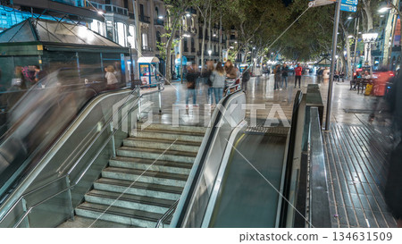 Exit from metro to La Rambla street in Barcelona night timelapse, Spain. 134631509