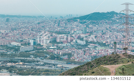 Barcelona and Badalona skyline with roofs of houses and sea on the horizon at evening timelapse Barcelona and Badalona skyline with roofs of houses and sea on the horizon at evening timelapse 134631512