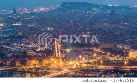 Barcelona and Badalona skyline with roofs of houses and sea on the horizon day to night timelapse 134631519
