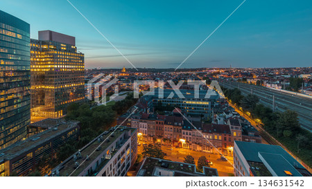 Aerial day to night timelapse of Brussels urban landscape blending office skyscrapers with residential areas. Aerial day to night timelapse of Brussels urban landscape blending office skyscrapers with residential areas. 134631542