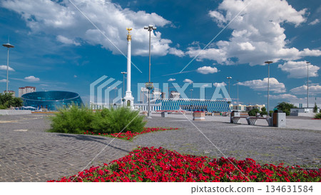 Stele monument Kazakh Eli with bird Samruk and Palace of Independence timelapse hyperlapse. 134631584