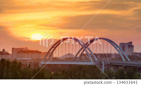 Sunset timelapse above the Bridge with the transport and clouds on the background. Central Asia, Kazakhstan, Astana Sunset timelapse above the Bridge with the transport and clouds on the background. Central Asia, Kazakhstan, Astana 134631641