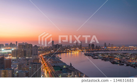 Cityscape of Ajman from rooftop day to night timelapse after sunset. 134631683