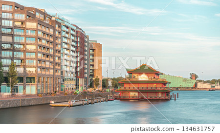 Hyperlapse of pagoda on the water, set against the backdrop of historical city center architecture at sunset timelapse. Amsterdam, Netherlands 134631757